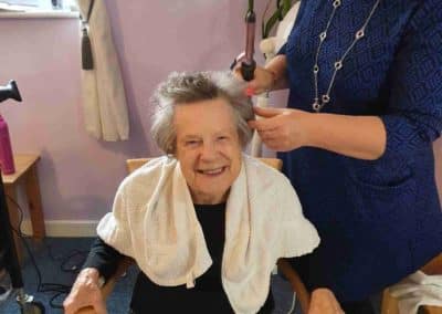 care home resident having hair curled