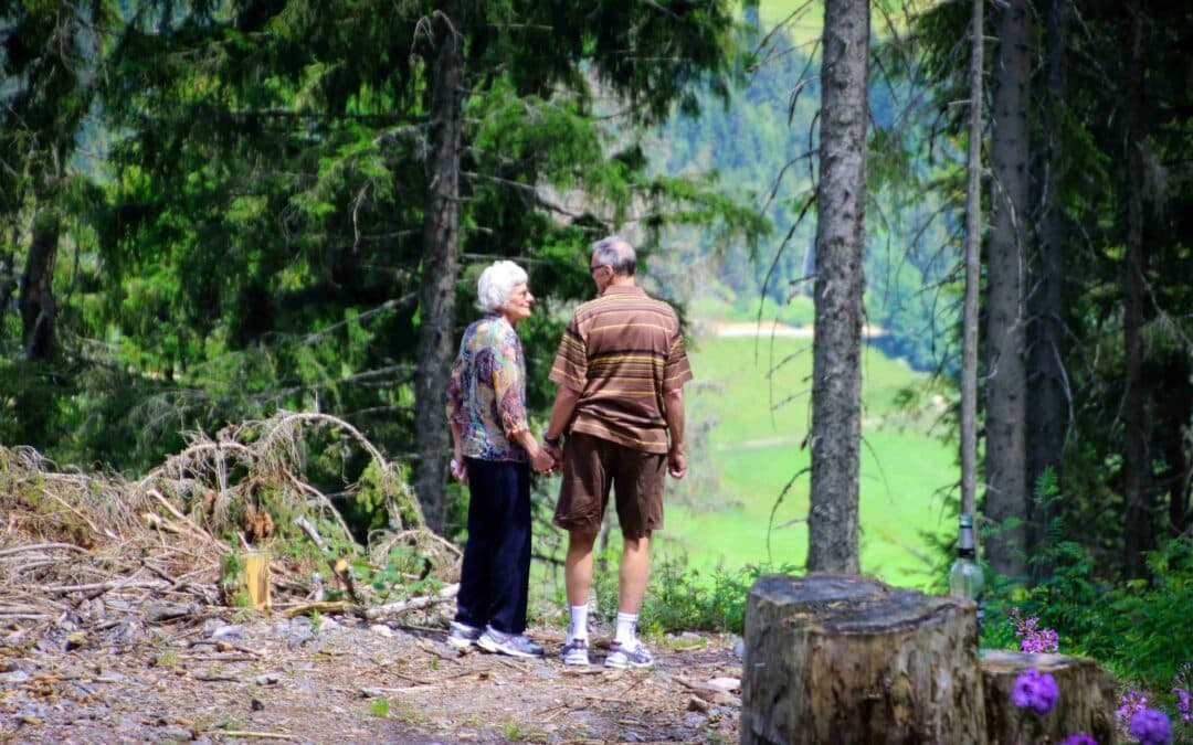 elderly couple on a walk in the woods